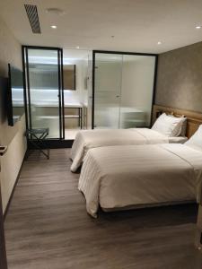 Ένα ή περισσότερα κρεβάτια σε δωμάτιο στο City Suites - Taoyuan Station