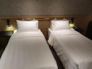 Ένα ή περισσότερα κρεβάτια σε δωμάτιο στο City Suites - Taoyuan Station