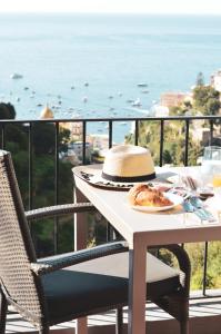 a table with a plate of food on a balcony at Il Canneto in Positano