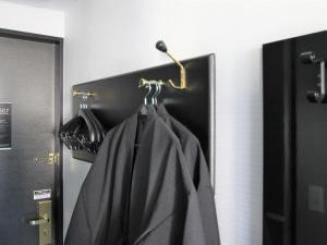 a door with a towel hanging on a rack at APA Hotel & Resort Yokohama Bay Tower in Yokohama