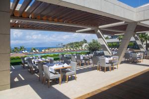 a restaurant with tables and chairs on a patio at ON'LIVE HOTEL in Çeşme