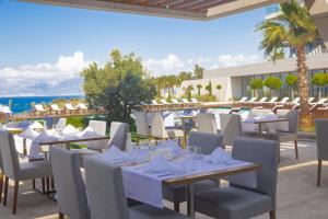 a restaurant with tables and chairs with a view of the ocean at ON'LIVE HOTEL in Çeşme