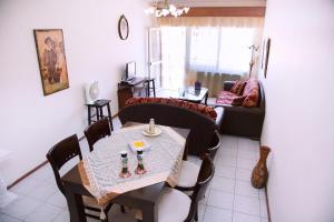 a living room with a table and a couch at Comfortable House with Warm Hospitality in Katerini