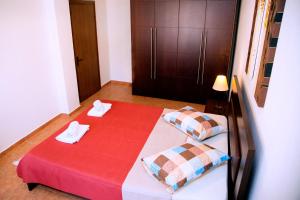 a bedroom with a bed with two towels on it at Comfortable House with Warm Hospitality in Katerini
