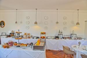a room with two tables with white table cloth at Hôtel La Villa Cap d’Antibes in Juan-les-Pins