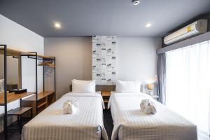 Ένα ή περισσότερα κρεβάτια σε δωμάτιο στο U- Homehotel Nakhonpanom