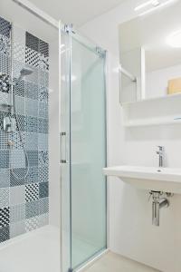 a bathroom with a glass shower and a sink at Apartmány Dolní Morava in Dolní Morava