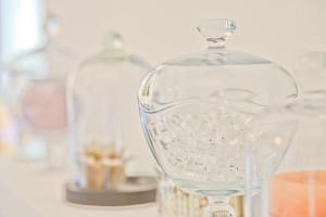 a glass bottle sitting on top of a table at Hôtel La Villa Cap d’Antibes in Juan-les-Pins