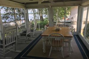 a screened porch with a table and chairs at 4 Bed 2 Bath Vacation home in Ossipee in Ossipee