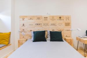 a bedroom with a bed with a wooden wall at APOSENTUS - The Wine Studio in Porto