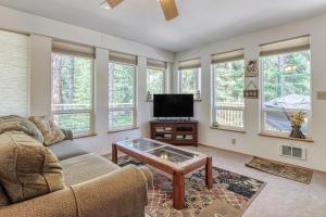 a living room with a couch and a tv at Towering Pines Cabin & Game Room in Leavenworth