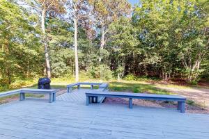 three benches sitting on a patio in a park at 3 Bed 2 Bath Vacation home in West Tisbury in West Tisbury