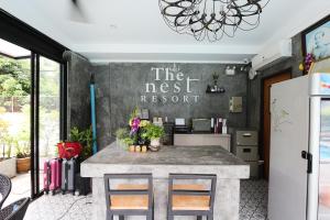 a kitchen with a counter and a refrigerator at The Nest Resort Patong in Patong Beach