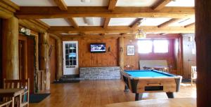 a large room with a pool table in it at Stonybrook Motel & Lodge in Franconia