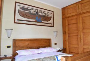 a bedroom with a bed and a poster on the wall at Albergo Ristorante Conca Azzurra in Colico