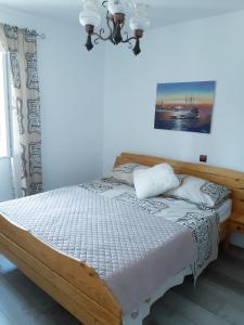 a bedroom with a wooden bed in a room at apartman Marina in Sutivan