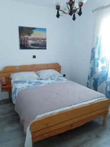 a bedroom with a wooden bed in a room at apartman Marina in Sutivan