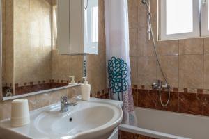 a bathroom with a sink and a shower and a tub at Apartments Jure in Makarska