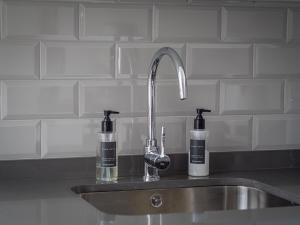 un fregadero con dos botellas de jabón. en Marbella Old Town : Luxury Townhouse, en Marbella 32 fotos más