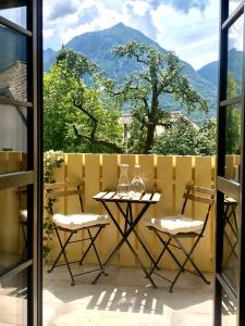 a table and two chairs on a balcony with a view at Summer House Bovec in Bovec