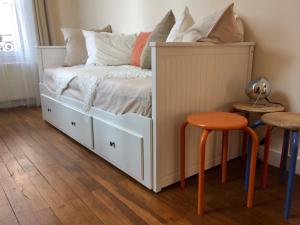 a bedroom with a bed and two stools at La Terrasse des bords du Cher in Saint-Aignan