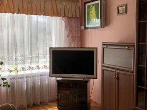 a flat screen tv sitting in front of a window at Здається квартира подобово in Kamianets-Podilskyi +1 photo