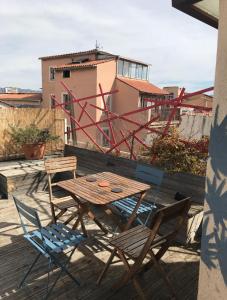 a wooden table and chairs sitting on a patio at Maison Du Vieux Panier Vieux Port in Marseille