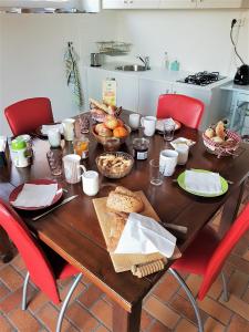 a wooden table with food on it in a kitchen at Le Domaine des Prés in Lachambre