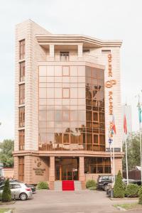 a building with a sign on the front of it at Golden Palace Hotel in Almaty