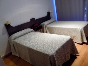 A bed or beds in a room at Hotel Lisboa