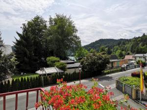 a view from a balcony of a town with flowers at Hotel Auszeit in Sankt Kanzian