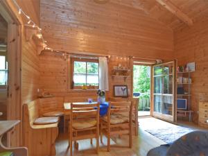 a dining room with a table and chairs in a cabin at Vintage Holiday Home in Grafenried with Garden in Drachselsried