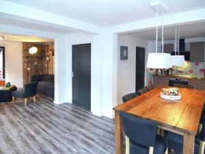 a dining room and living room with a table and chairs at Modern holiday home in Hessen with private terrace in Trubenhausen