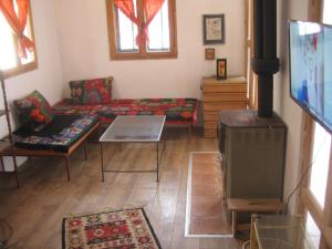 a living room with a couch and a table at Cosy Cottage on Avala Mountain in Belgrade