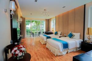a hotel room with two beds and a balcony at FLC Luxury Resort Vinh Phuc in Hoằng Xá