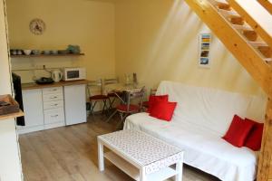 a living room with a white couch and red pillows at Apartmán Turista in Pavčina Lehota