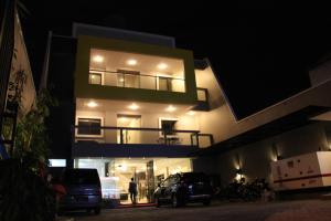 a building with a car parked in front of it at night at SWK 95 Hotel in Surabaya