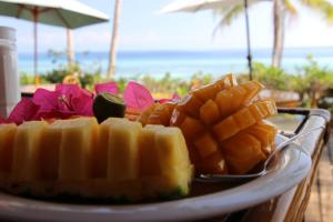 a plate of food on a table with fruit and vegetables at VILLA MARMARINE BEACH RESORT & RESTAURANT in Siquijor