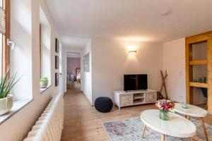 a living room with two tables and a television at P45 in Erfurt