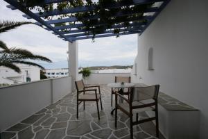 a patio with chairs and a table on a balcony at Pension Sofia in Parikia