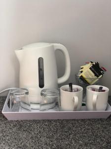 a coffee maker on a tray with cups on it at Fairwinds in Inverness