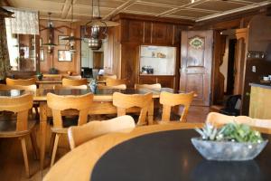 a dining room with wooden tables and chairs at Gasthof zur Sonne in Stäfa