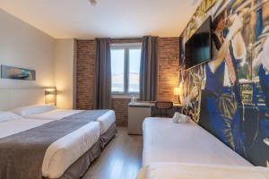 Postel nebo postele na pokoji v ubytování Colectia Hotel Urumea