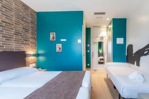 Postel nebo postele na pokoji v ubytování Colectia Hotel Urumea