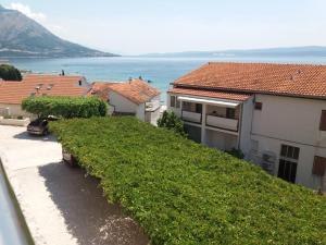 a row of houses with the ocean in the background at Apartmani "Grgic" in Omiš