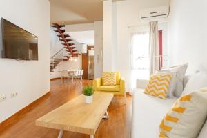 a living room with a couch and a table at Apartamentos Sherry Center in Jerez de la Frontera