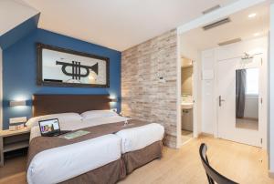 1 dormitorio con 1 cama grande y pared azul en Casual del Jazz San Sebastián, en San Sebastián