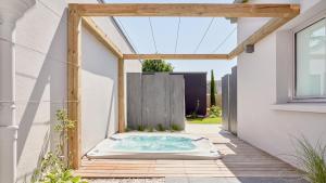 a hot tub in the courtyard of a house at Maison Tiegezh in Guer