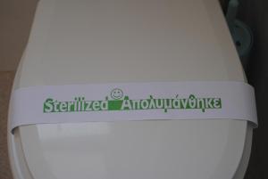 a sticker on the side of a toilet seat at Maria Rooms in Agia Ermioni +38 photos