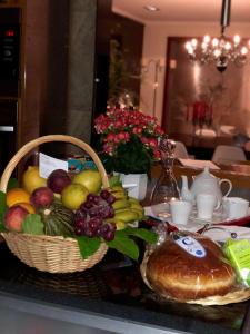 a table with a basket of fruit and a bread at Quinta Da Bela Vista in Ponta Delgada